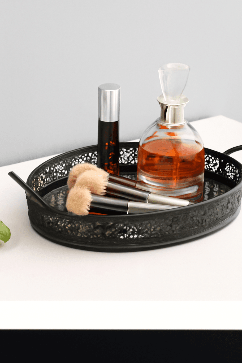 Black mirrored vanity tray styled with perfume bottles and jewellery